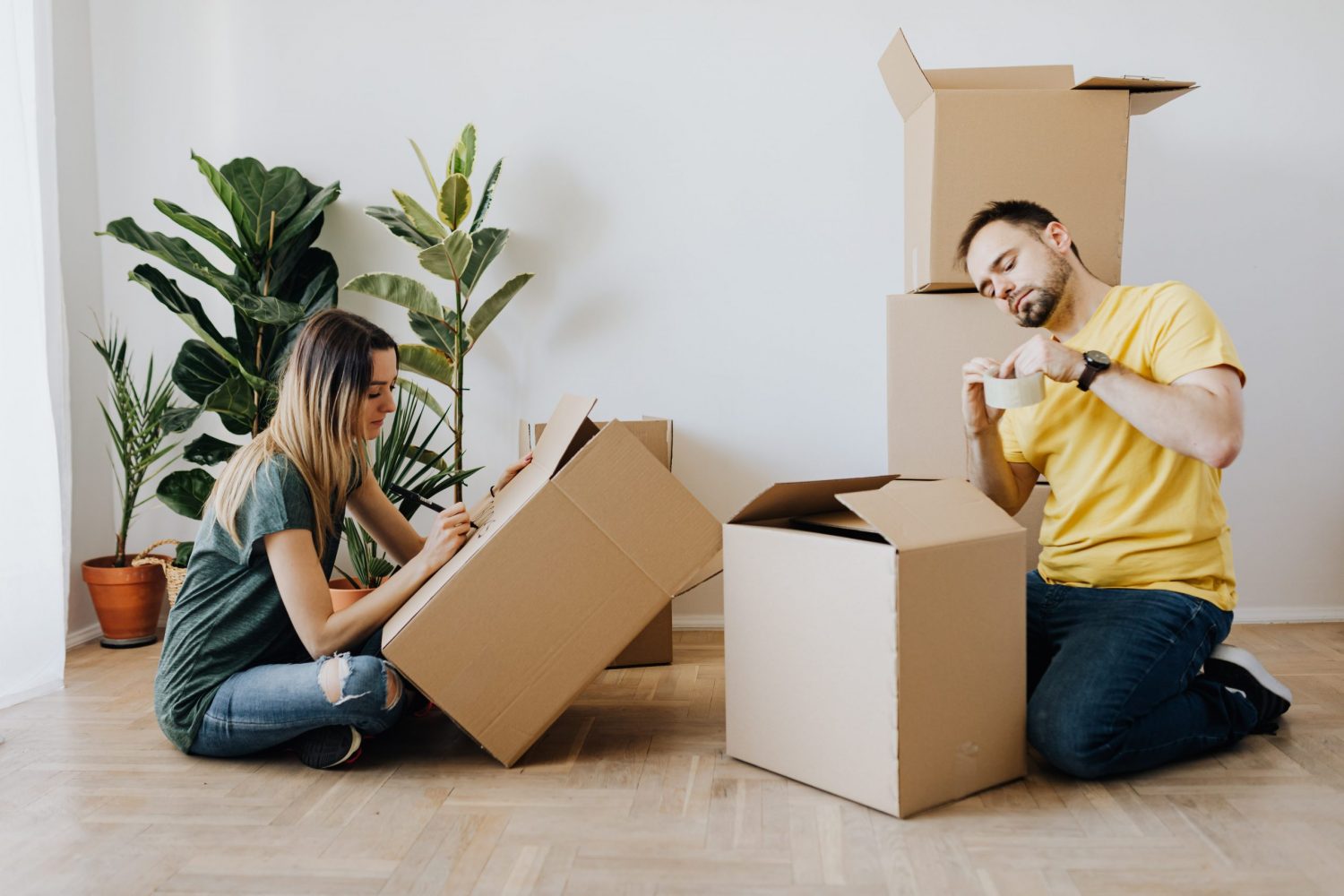 content-couple-packing-belongings-into-carton-boxes-4506258